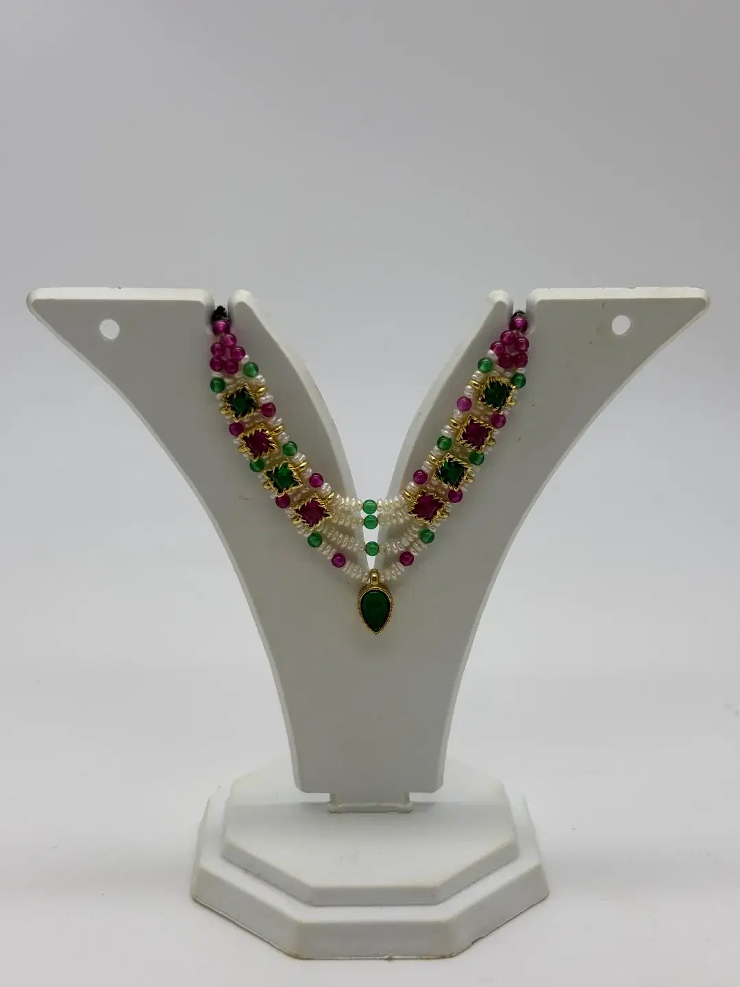 Three-strand freshwater pearl milma haar with silver chowkis, ruby and emerald beads, and emerald drop for Laddu Gopal