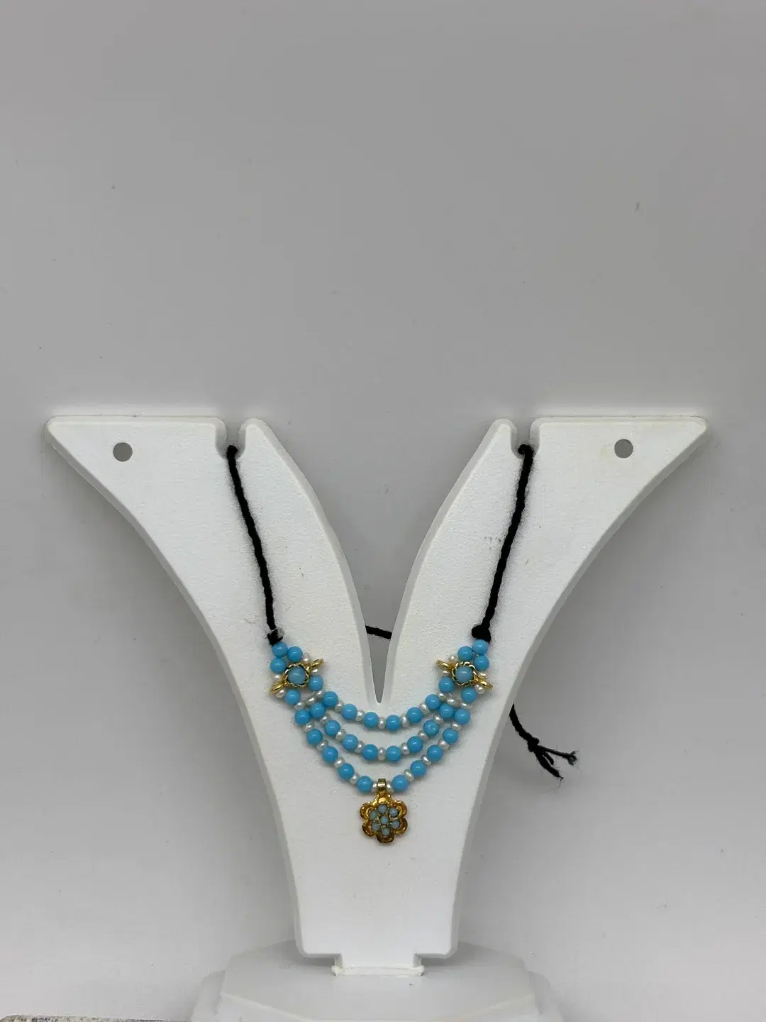 Three-tier turquoise bead and pearl haar with silver floral side chowkis and rosette pendant for Laddu Gopal
