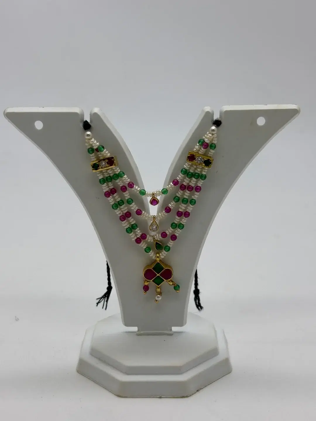 Three-strand milma pearl and gemstone haar with silver AD chowkis and four-quadrant kundan padak for Laddu Gopal
