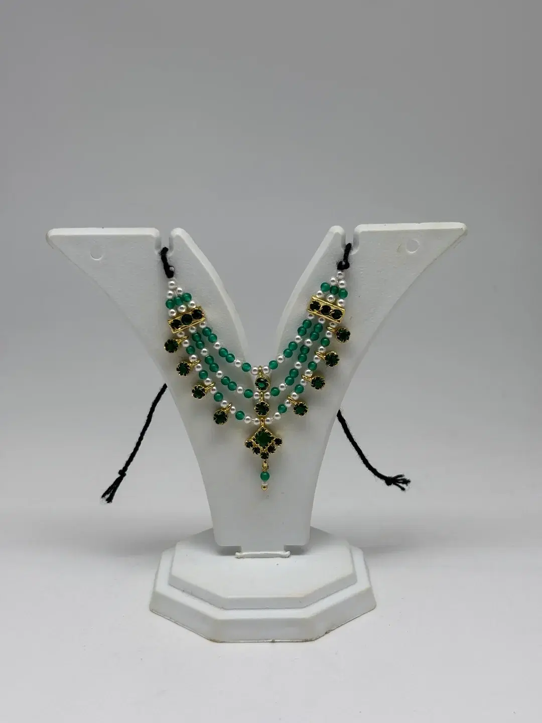 Three-tier emerald green bead and pearl haar with silver chowkis and diamond-shaped pendant for Laddu Gopal