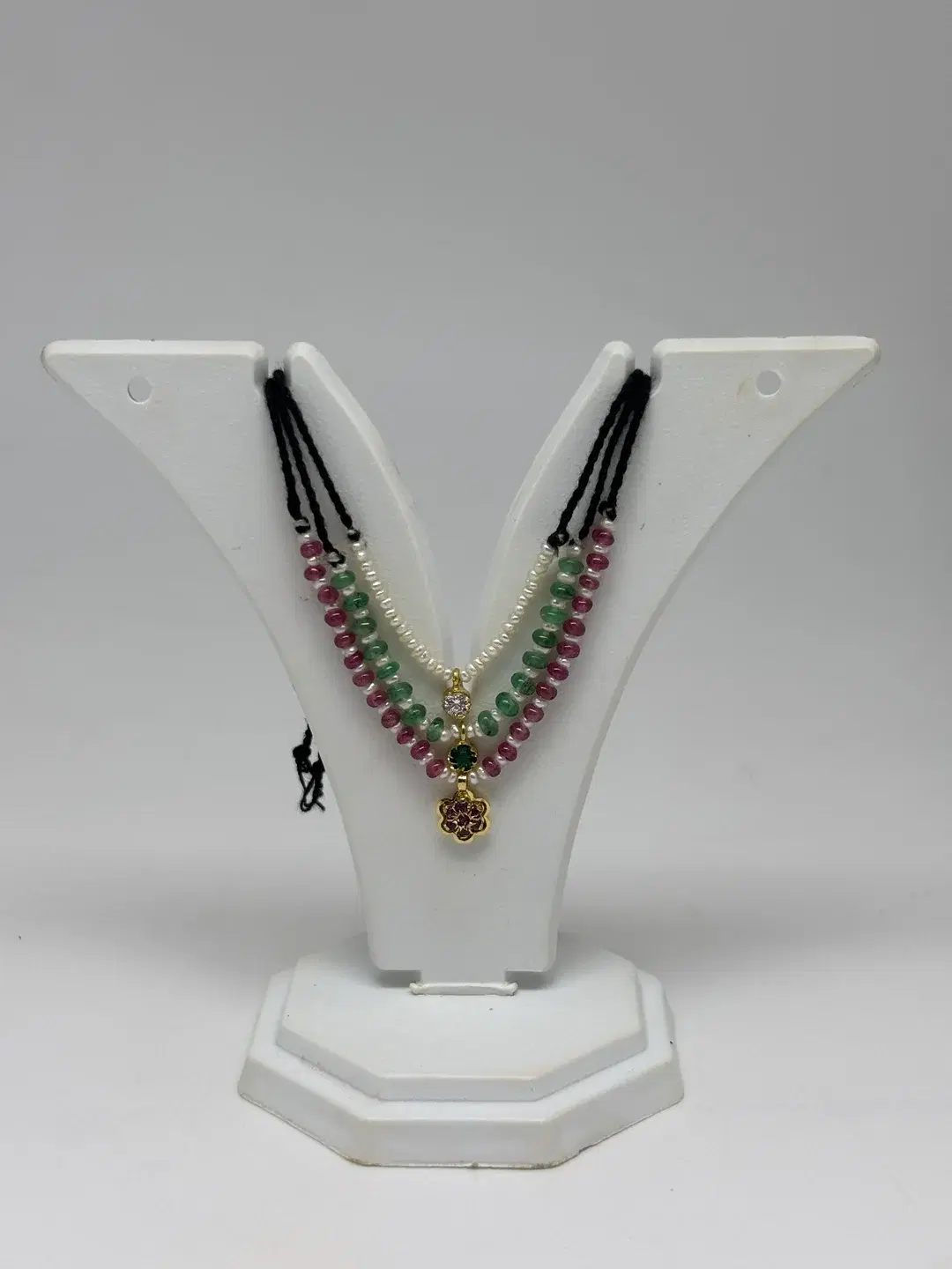 Three-tier pearl, emerald, and ruby bead mala with silver connector and floral rosette pendant for Laddu Gopal