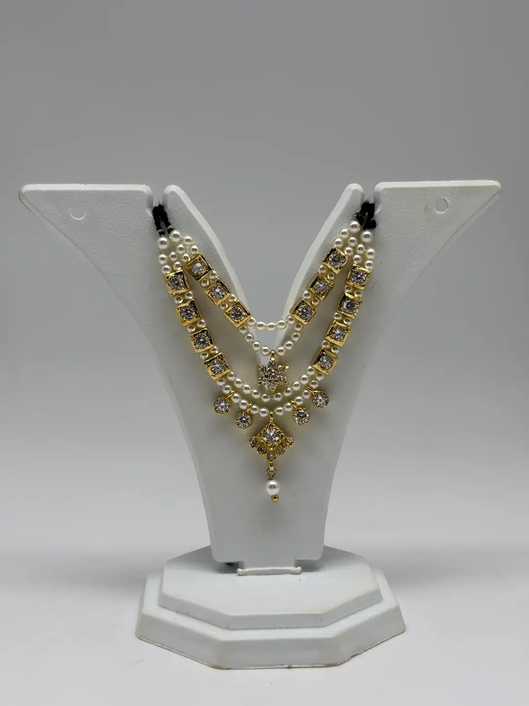 Three-strand pearl heera haar with square silver AD chowkis and star connector pendant for Laddu Gopal